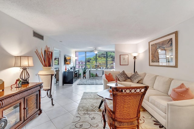 15075 Witney Rd Unit 212, Delray Beach, FL 33484 - living room featuring light tile patterned flooring, a textured ceiling, a ceiling fan, and expansive windows