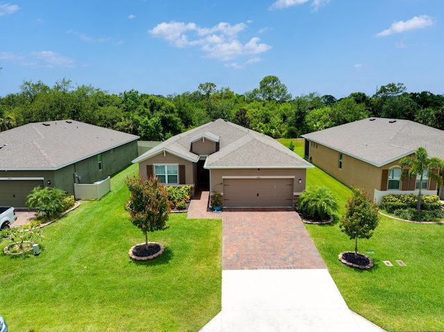 2431 Crowned Eagle Cir SW, Vero Beach, FL 32962 - ranch-style house featuring driveway, an attached garage, stucco siding, and a front yard