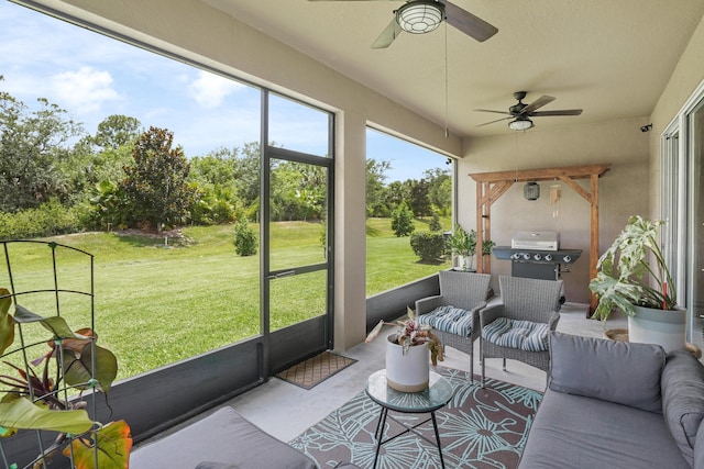 2431 Crowned Eagle Cir SW, Vero Beach, FL 32962 - sunroom featuring ceiling fan, an outdoor living space, exterior kitchen, and view of wooded area
