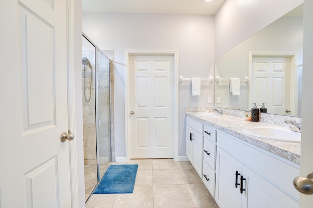2431 Crowned Eagle Cir SW, Vero Beach, FL 32962 - bathroom featuring double vanity, a stall shower, tile patterned floors, and baseboards