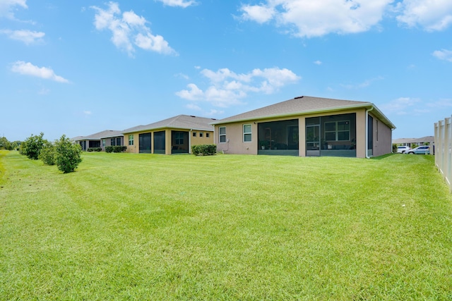 2431 Crowned Eagle Cir SW, Vero Beach, FL 32962 - back of house with a sunroom, a lawn, and stucco siding