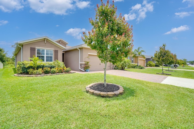 2431 Crowned Eagle Cir SW, Vero Beach, FL 32962 - view of front of house featuring driveway, stucco siding, a front lawn, and an attached garage