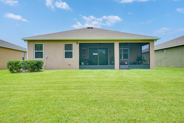 2431 Crowned Eagle Cir SW, Vero Beach, FL 32962 - rear view of house with a sunroom, a lawn, and stucco siding