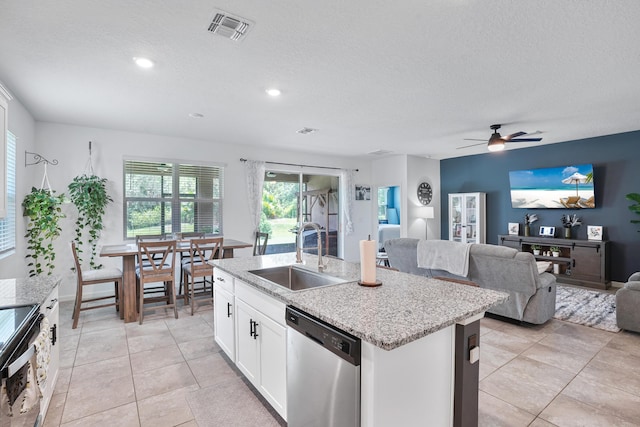 2431 Crowned Eagle Cir SW, Vero Beach, FL 32962 - kitchen with stainless steel appliances, a sink, open floor plan, plenty of natural light, and a textured ceiling