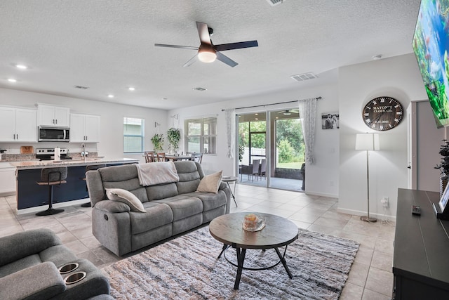 2431 Crowned Eagle Cir SW, Vero Beach, FL 32962 - living area with ceiling fan, light tile patterned flooring, a textured ceiling, baseboards, and recessed lighting