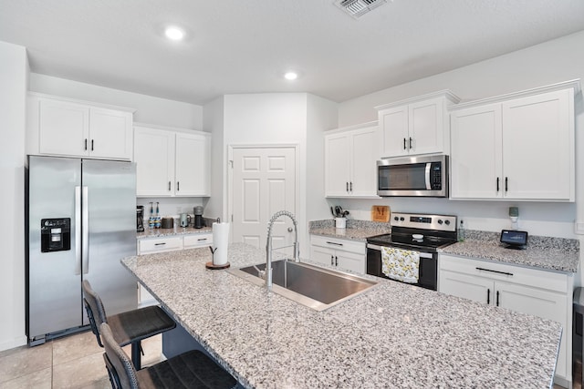 2431 Crowned Eagle Cir SW, Vero Beach, FL 32962 - kitchen with appliances with stainless steel finishes, a sink, an island with sink, white cabinets, and recessed lighting