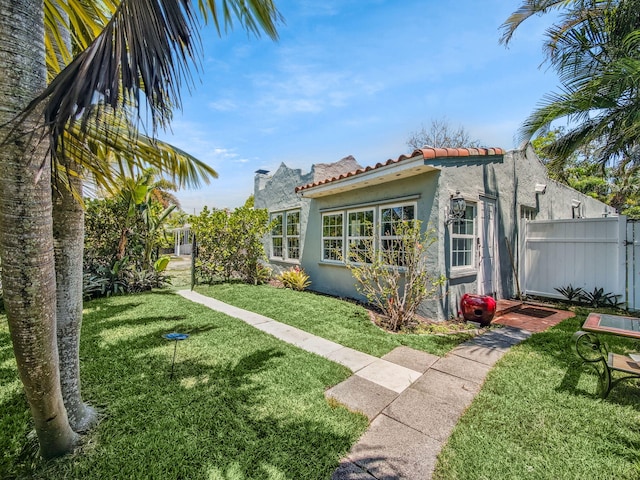 505 Palmetto St, West Palm Beach, FL 33405 - rear view of property with stucco siding and a tiled roof