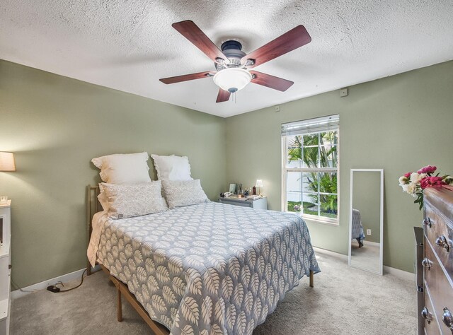 505 Palmetto St, West Palm Beach, FL 33405 - bedroom with carpet flooring, baseboards, a ceiling fan, and a textured ceiling