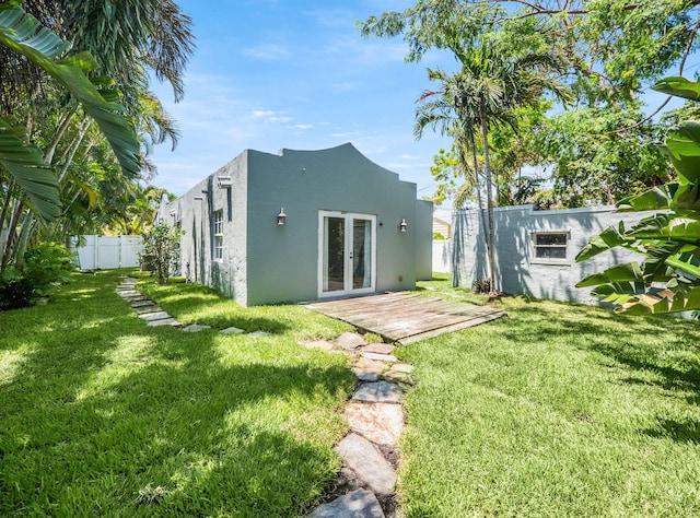 505 Palmetto St, West Palm Beach, FL 33405 - back of property with french doors and stucco siding