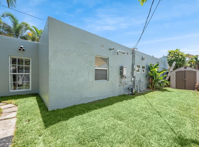 505 Palmetto St, West Palm Beach, FL 33405 - rear view of house featuring stucco siding and a yard