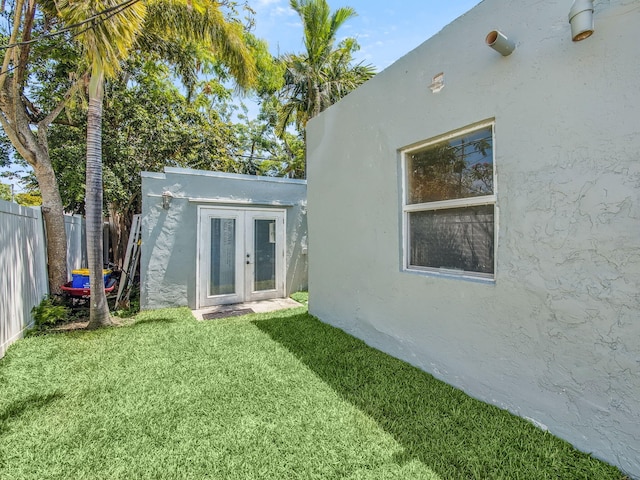 505 Palmetto St, West Palm Beach, FL 33405 - rear view of property with stucco siding and french doors