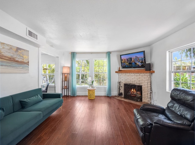 505 Palmetto St, West Palm Beach, FL 33405 - living room with a fireplace, hardwood / wood-style flooring, and a textured ceiling