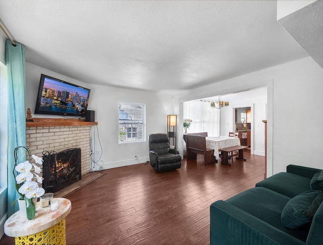 505 Palmetto St, West Palm Beach, FL 33405 - living area with a chandelier, a fireplace, hardwood / wood-style floors, a textured ceiling, and baseboards