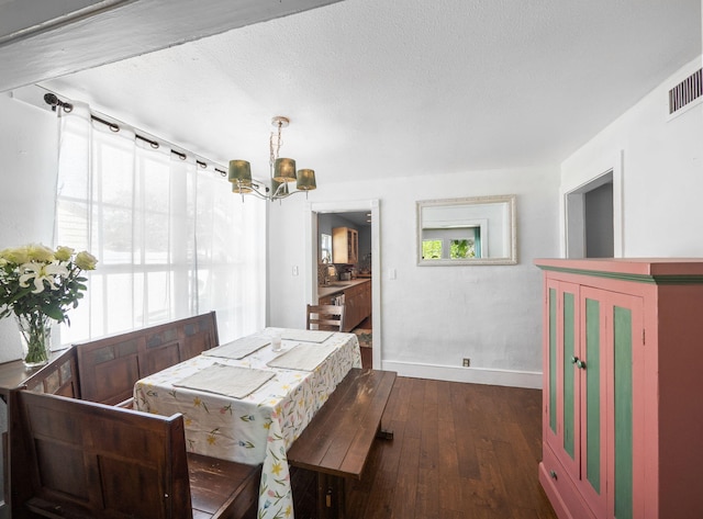 505 Palmetto St, West Palm Beach, FL 33405 - dining area featuring a chandelier, baseboards, and dark wood-style floors