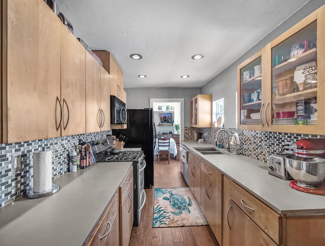 505 Palmetto St, West Palm Beach, FL 33405 - kitchen with appliances with stainless steel finishes, a sink, light countertops, light wood-style floors, and recessed lighting