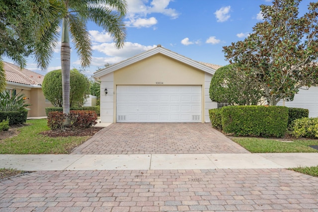 10834 SW Dardanelle Dr, Port Saint Lucie, FL 34987 - view of front of property with stucco siding and decorative driveway