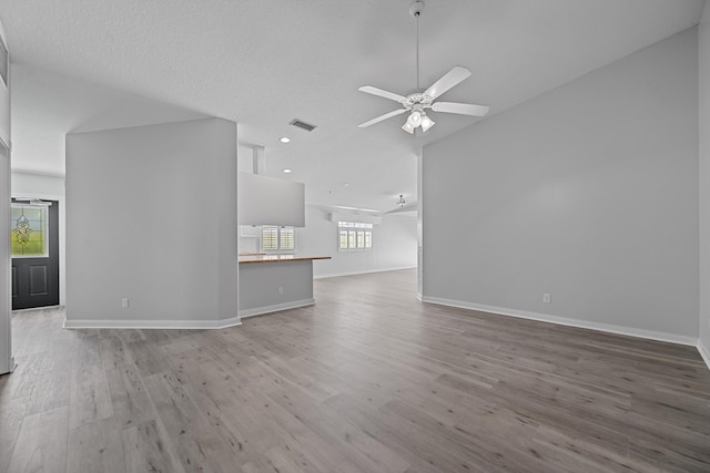 10834 SW Dardanelle Dr, Port Saint Lucie, FL 34987 - unfurnished living room with wood finished floors, a ceiling fan, vaulted ceiling, baseboards, and recessed lighting