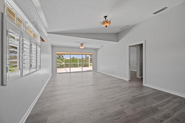 10834 SW Dardanelle Dr, Port Saint Lucie, FL 34987 - empty room with a textured ceiling, ceiling fan, wood finished floors, baseboards, and vaulted ceiling