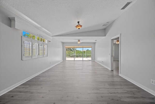 10834 SW Dardanelle Dr, Port Saint Lucie, FL 34987 - unfurnished room with a ceiling fan, a textured ceiling, vaulted ceiling, wood finished floors, and baseboards