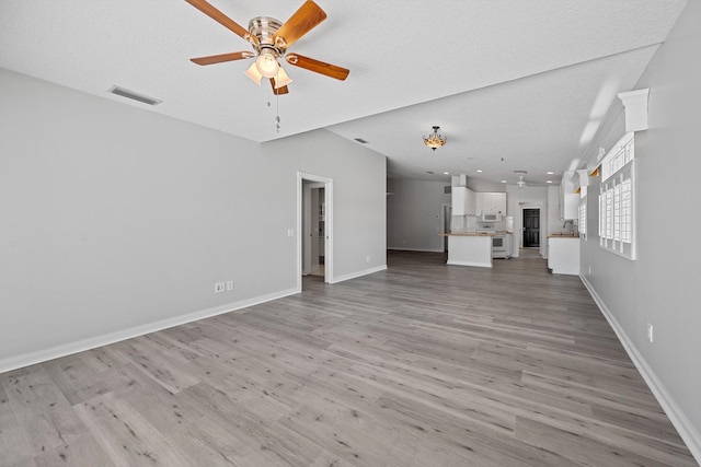 10834 SW Dardanelle Dr, Port Saint Lucie, FL 34987 - unfurnished living room with a ceiling fan, light wood-style flooring, and baseboards