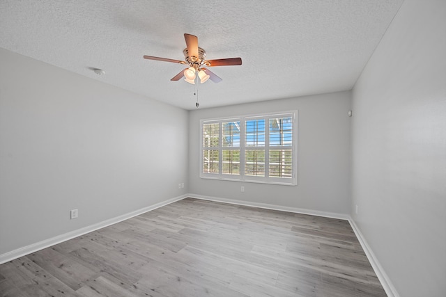 10834 SW Dardanelle Dr, Port Saint Lucie, FL 34987 - unfurnished room featuring a textured ceiling, ceiling fan, wood finished floors, a smoke detector, and baseboards
