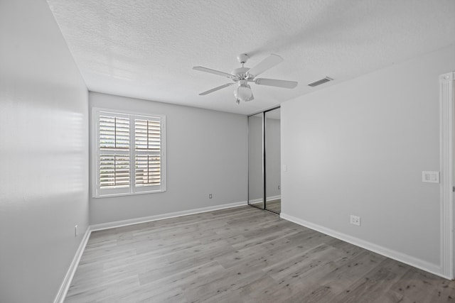 10834 SW Dardanelle Dr, Port Saint Lucie, FL 34987 - unfurnished room featuring ceiling fan, wood finished floors, a textured ceiling, and baseboards