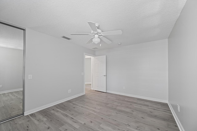 10834 SW Dardanelle Dr, Port Saint Lucie, FL 34987 - unfurnished bedroom featuring wood finished floors, a textured ceiling, a closet, and baseboards