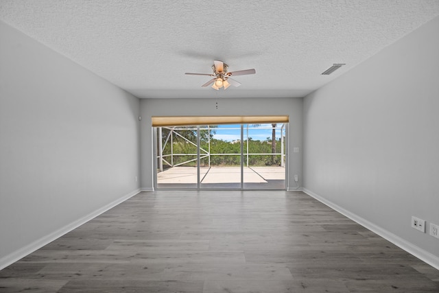 10834 SW Dardanelle Dr, Port Saint Lucie, FL 34987 - spare room featuring wood finished floors, a ceiling fan, a textured ceiling, and baseboards