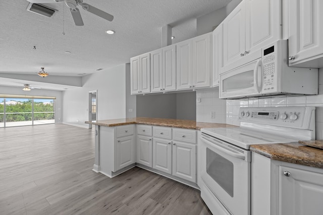 10834 SW Dardanelle Dr, Port Saint Lucie, FL 34987 - kitchen with white appliances, a ceiling fan, white cabinetry, a peninsula, and a textured ceiling
