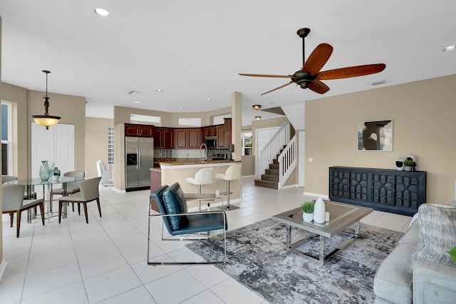 3559 Hudson Ln, Boynton Beach, FL 33436 - living area featuring ceiling fan, light tile patterned floors, healthy amount of natural light, recessed lighting, and stairs