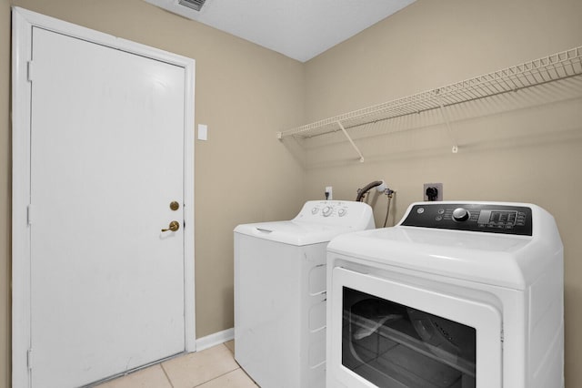 3559 Hudson Ln, Boynton Beach, FL 33436 - laundry room featuring washing machine and clothes dryer and light tile patterned flooring