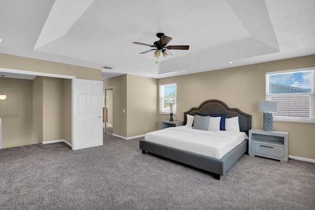 3559 Hudson Ln, Boynton Beach, FL 33436 - carpeted bedroom with a tray ceiling and a ceiling fan
