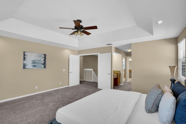 3559 Hudson Ln, Boynton Beach, FL 33436 - bedroom with a raised ceiling, dark carpet, recessed lighting, connected bathroom, and a ceiling fan