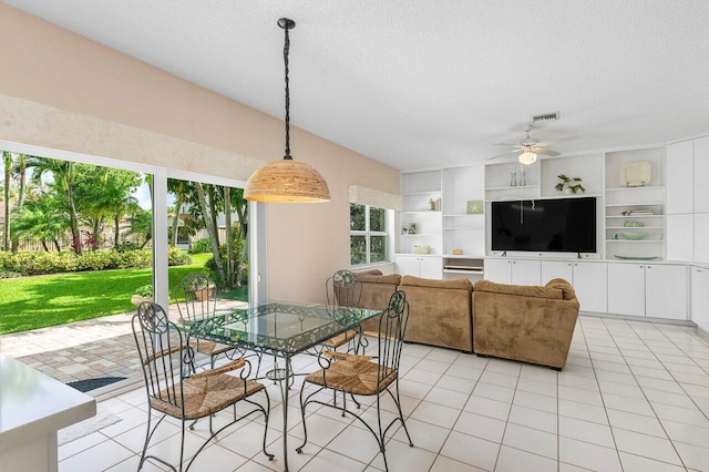 6321 Lansdowne Cir, Boynton Beach, FL 33472 - dining space featuring a textured ceiling, a ceiling fan, light tile patterned flooring, and built in shelves