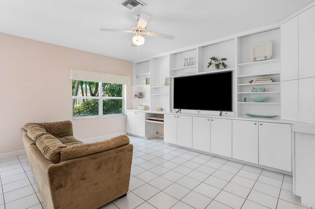 6321 Lansdowne Cir, Boynton Beach, FL 33472 - living area with a textured ceiling, light tile patterned flooring, a ceiling fan, and baseboards