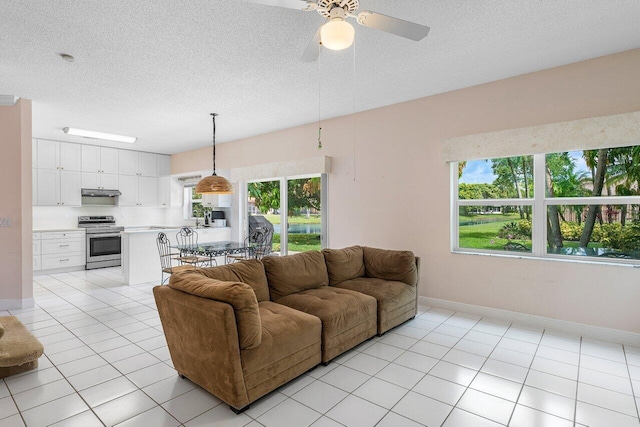 6321 Lansdowne Cir, Boynton Beach, FL 33472 - living room with light tile patterned flooring, a ceiling fan, a textured ceiling, and baseboards