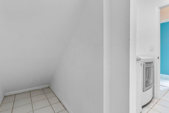 6321 Lansdowne Cir, Boynton Beach, FL 33472 - laundry area with washer and clothes dryer, light tile patterned flooring, and baseboards