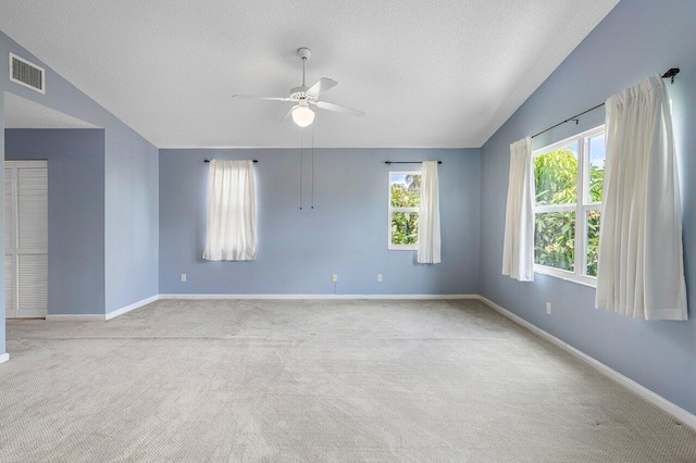 6321 Lansdowne Cir, Boynton Beach, FL 33472 - carpeted empty room featuring ceiling fan, a textured ceiling, healthy amount of natural light, baseboards, and lofted ceiling