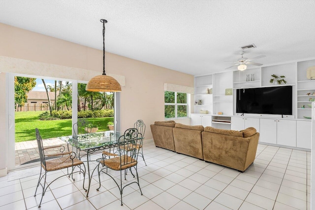 6321 Lansdowne Cir, Boynton Beach, FL 33472 - dining room with plenty of natural light, a textured ceiling, a ceiling fan, and light tile patterned flooring