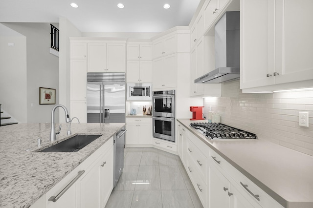 9350 Eden Roc Ct, Delray Beach, FL 33446 - kitchen featuring wall chimney range hood, a sink, built in appliances, backsplash, and recessed lighting
