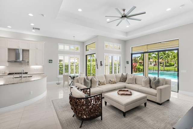 9350 Eden Roc Ct, Delray Beach, FL 33446 - living area with recessed lighting, baseboards, a ceiling fan, a raised ceiling, and light tile patterned floors