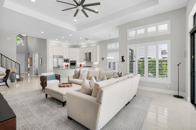 9350 Eden Roc Ct, Delray Beach, FL 33446 - living room featuring ceiling fan, a towering ceiling, recessed lighting, healthy amount of natural light, and a tray ceiling