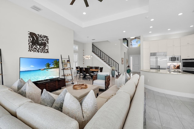 9350 Eden Roc Ct, Delray Beach, FL 33446 - living area with stairs, recessed lighting, a chandelier, a ceiling fan, and a high ceiling