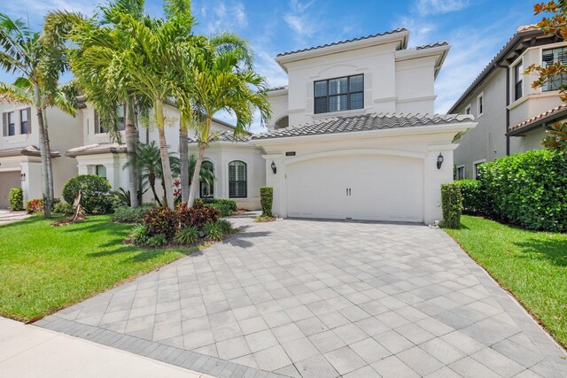 9350 Eden Roc Ct, Delray Beach, FL 33446 - mediterranean / spanish-style home with a tile roof, decorative driveway, a front lawn, stucco siding, and a garage