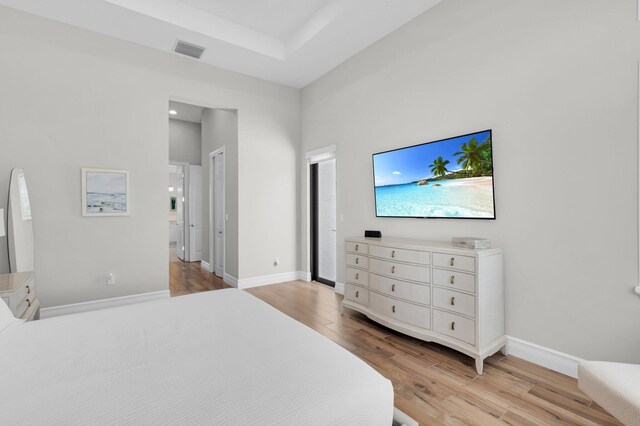 9350 Eden Roc Ct, Delray Beach, FL 33446 - bedroom with light wood-style flooring, baseboards, and connected bathroom