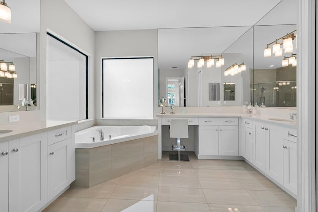 9350 Eden Roc Ct, Delray Beach, FL 33446 - bathroom featuring a stall shower, two vanities, a garden tub, and tile patterned flooring