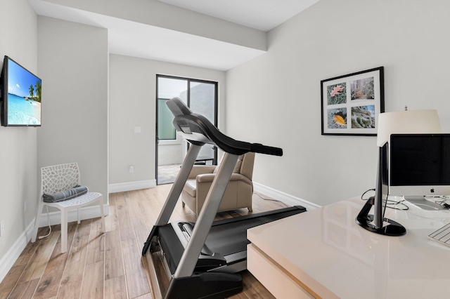 9350 Eden Roc Ct, Delray Beach, FL 33446 - workout room with light wood-style flooring and baseboards