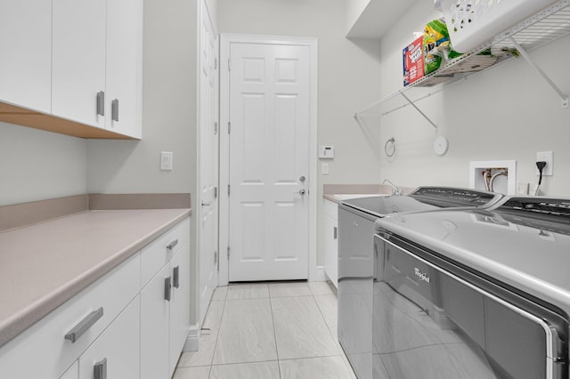 9350 Eden Roc Ct, Delray Beach, FL 33446 - laundry area featuring washer and dryer, cabinet space, and light tile patterned floors