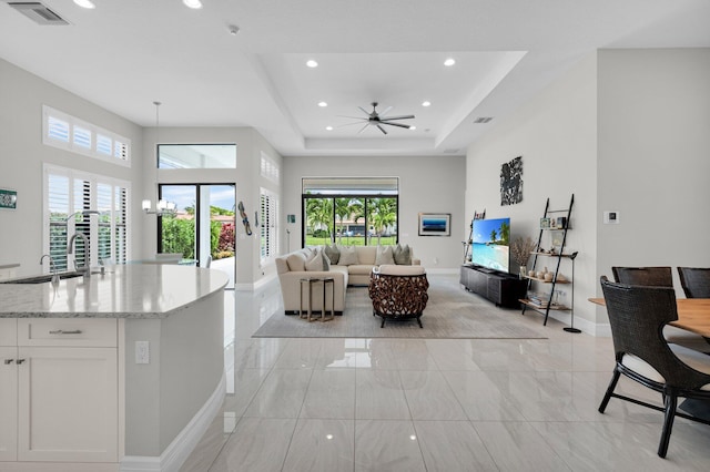 9350 Eden Roc Ct, Delray Beach, FL 33446 - living area with baseboards, light marble finish floors, recessed lighting, ceiling fan, and a tray ceiling
