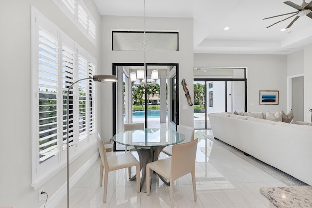 9350 Eden Roc Ct, Delray Beach, FL 33446 - dining area with a ceiling fan, baseboards, a chandelier, a raised ceiling, and a towering ceiling